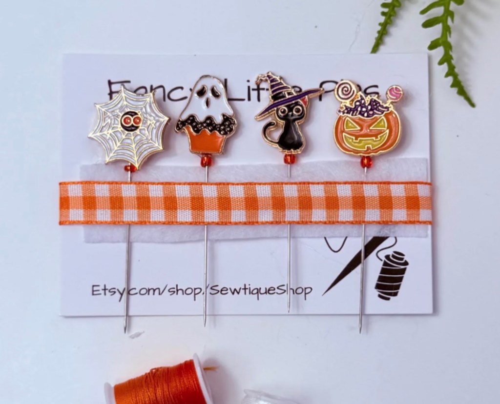 Decorative Halloween sewing pins – spider web, ghost cupcake, black cat with witch hat, and candy-filled jack-o’-lantern – handmade notions from Sewtique Shop